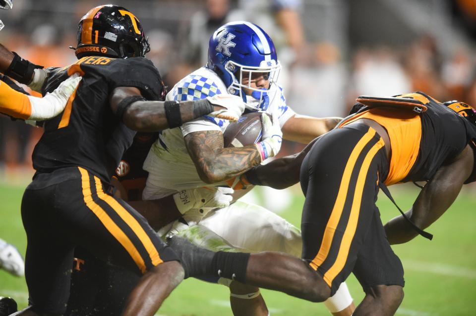 Kentucky running back Chris Rodriguez Jr. (24) gets swallowed by a sea of black during the NCAA football match between Tennessee and Kentucky in Knoxville, Tenn. on Saturday, Oct. 29, 2022.