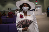 A women wearing a face mask attends a church service at the New Horizon International Church, Sunday, Oct. 4, 2020, in Jackson, Miss. The virus ripped through Mississippi's Black community early in the pandemic. About 60% of infections and deaths were among African Americans, who make up 38% of the state's population. (AP Photo/Wong Maye-E)