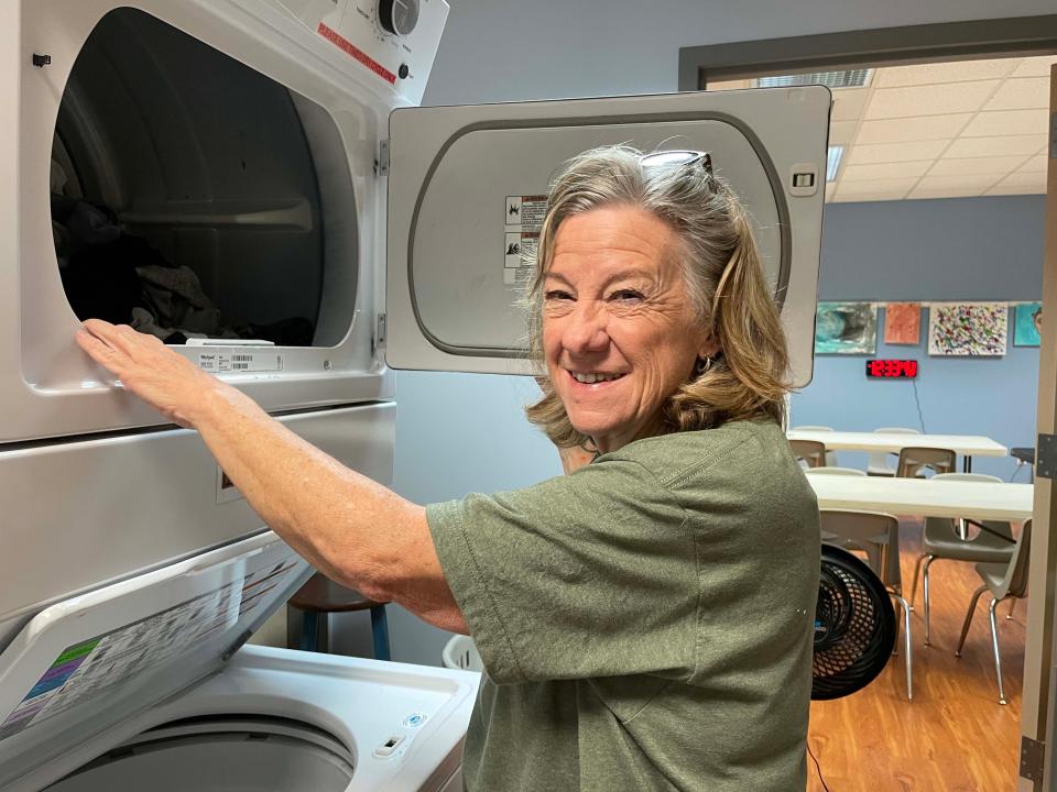 Volunteer Linda Wilson rotates laundry for a client at Fig Tree, a homeless community outreach program sponsored by Cokesbury United Methodist Church, on June 1, 2022.