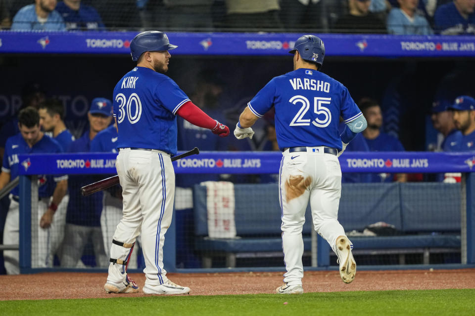 Toronto Blue Jays' Daulton Varsho (25) celebrates after his home run against the Houston Astros with teammate Alejandro Kirk (30) in eighth-inning baseball game action in Toronto, Ontario, Monday, June 5, 2023. (Andrew Lahodynskyj/The Canadian Press via AP)