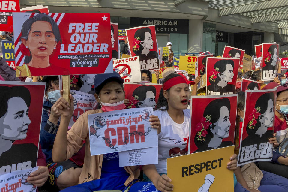 Demonstrators display images of detained Myanmar leader Aung San Suu Kyi during a protest against the military coup in Yangon, Myanmar, Tuesday, Feb. 16, 2021. Security forces in Myanmar pointed guns toward anti-coup protesters and attacked them with sticks Monday, seeking to quell the large-scale demonstrations calling for the military junta that seized power this month to reinstate the elected government. (AP Photo)