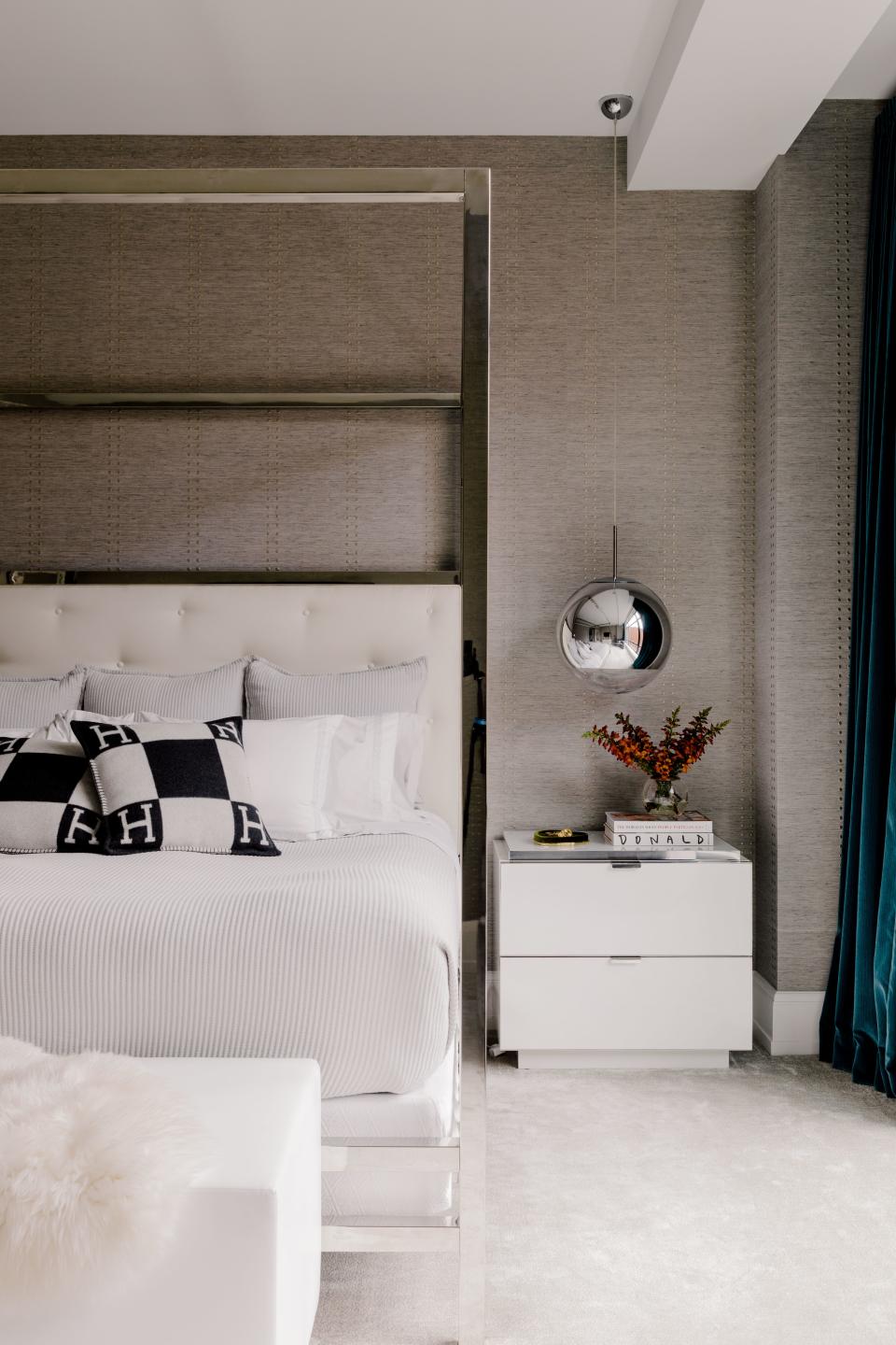 Charnas’ favorite room in the apartment is her bedroom. The wallpaper is Phillip Jeffries and the bed is by Bernhardt. The sleek pendant over the bedside table is from Tom Dixon.