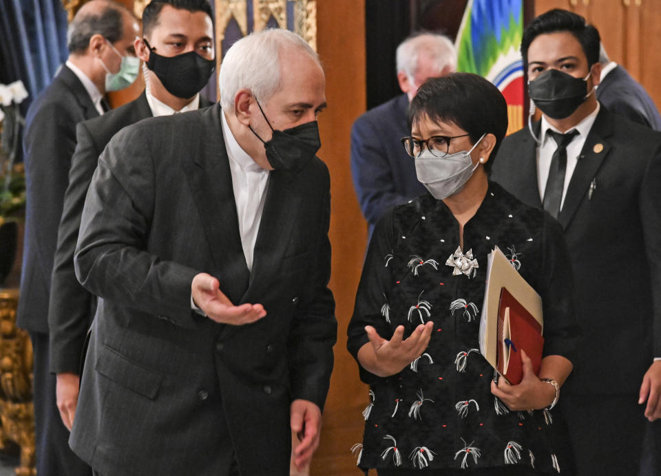 In this photo released by Indonesian Ministry of Foreign Affairs, Indonesian Foreign Minister Retno Marsudi, right, talks with her Iranian counterpart Mohammad Javad Zarif during their meeting in Jakarta, Indonesia, Monday, April 19, 2021. (Indonesian Ministry of Foreign Affairs via AP)