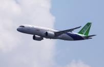 A Comac C919 flies past during an aerial flying display ahead of the Singapore Airshow at Changi Exhibition Centre in Singapore