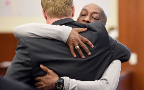 DeWayne Johnson hugs one of his lawyers after hearing the verdict  - Credit: JOSH EDELSON/AFP