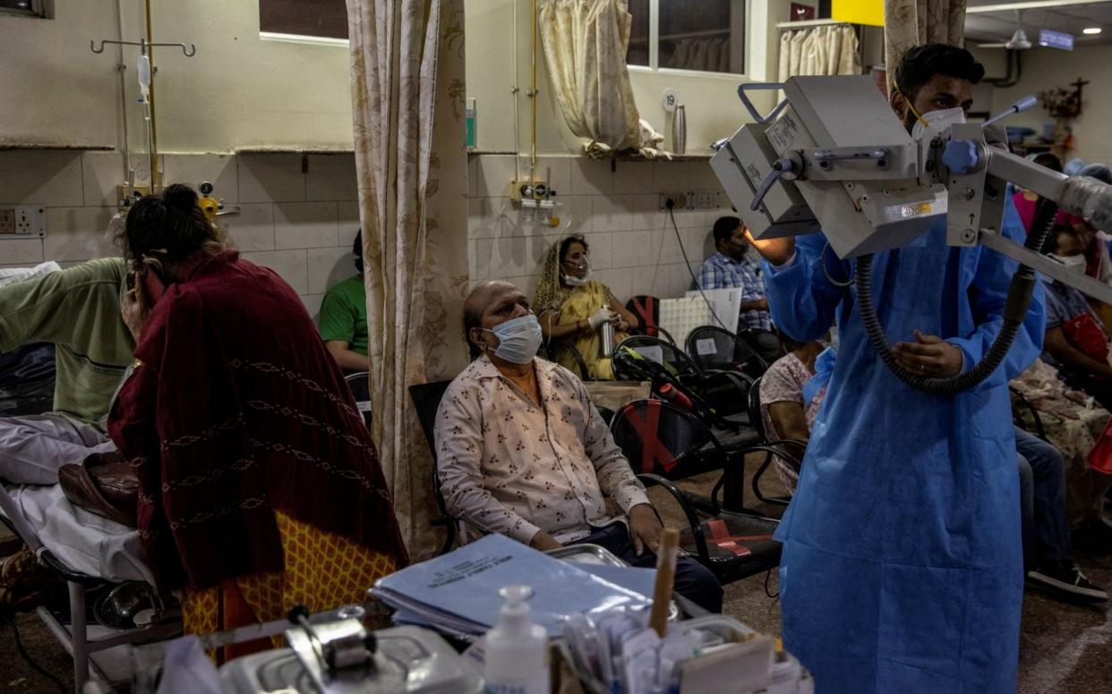 Patients suffering from the coronavirus disease (COVID-19) receive treatment inside the emergency ward at Holy Family hospital in New Delhi - Reuters