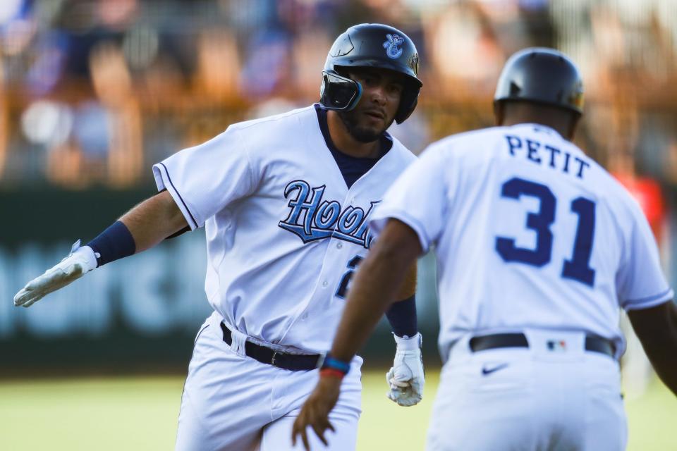 Hooks outfielder Wilyer Abreu (22) high fives manager Gregorio Petit after hitting a home run in a game against the Wichita Wind Surge on Tuesday, May 24, 2022 at Whataburger Field. The Hooks lost 8-3.