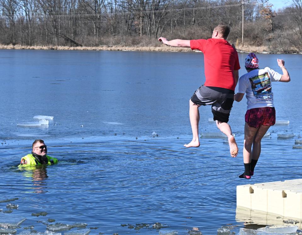 Quincy firefighters in cold water rescue suits stood by last year for jumpers in the Tip-Up Polar Bear Plunge in a frigid Marble Lake.