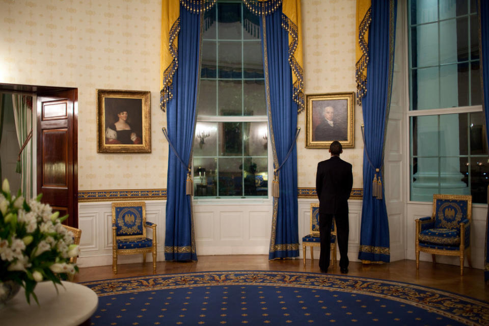 Obama looks at a portrait of President James Madison while waiting in the Blue Room of the White House before&nbsp;his press conference in the East Room on Feb. 9, 2009.