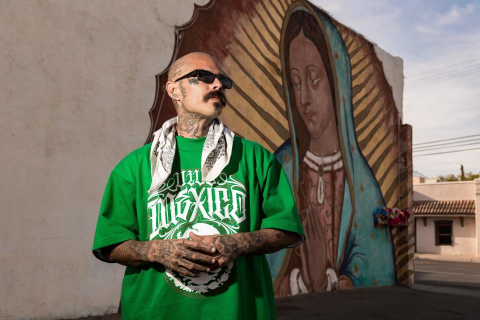 El Paso Chicano rap artist Fabian Primera 'Payaso915' stands by a well-known mural in Ysleta depicting 'La Virgen' on Saturday, May 20, 2023.