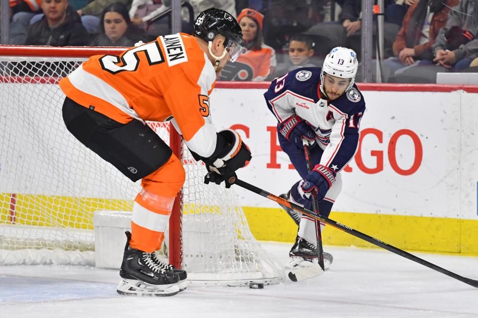 Dec 20, 2022; Philadelphia, Pennsylvania, USA; Columbus Blue Jackets left wing Johnny Gaudreau (13) is defended by Philadelphia Flyers defenseman Rasmus Ristolainen (55) during the first period at Wells Fargo Center. Mandatory Credit: Eric Hartline-USA TODAY Sports