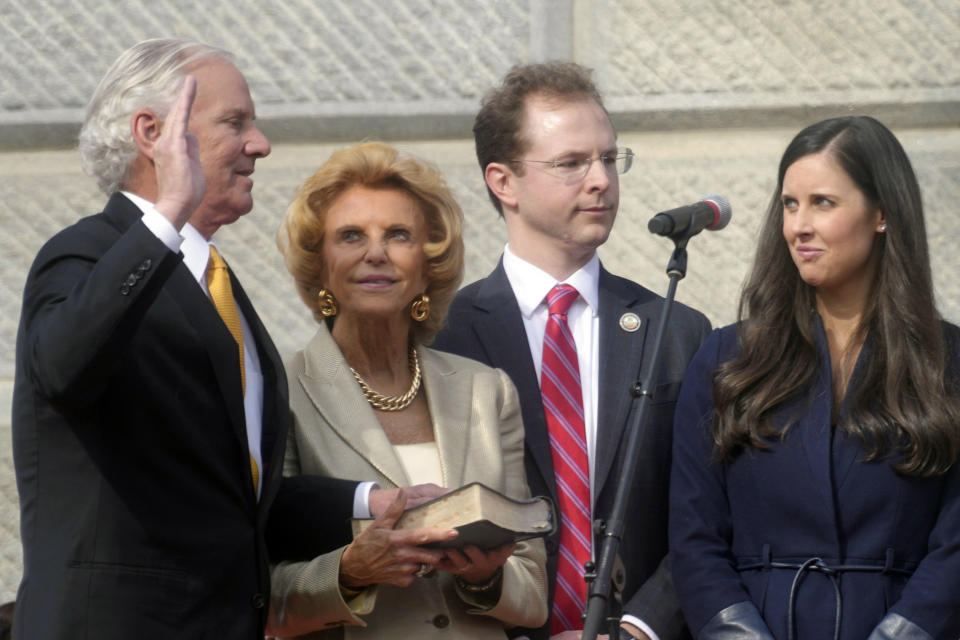 South Carolina Gov. Henry McMaster, left, takes the oath of office as his wife, Peggy McMaster, and other family members look on at his second inaugural on Wednesday, Jan. 11, 2023, in Columbia, S.C. (AP Photo/Meg Kinnard)