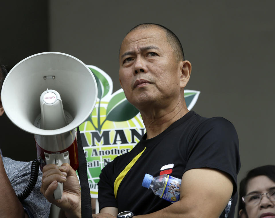 In this Feb. 20, 2014 photo, Roman Catholic priest Father Robert Reyes holds a megaphone for a speaker to protest the privatization of a government hospital that will pave the way for the construction of shopping malls in Quezon city northeast of Manila, Philippines. For more than 30 years, Reyes, dubbed the “running priest” by the local media, has been a constant critic of corruption in the Philippines and often times the church itself, which he charges has abandoned its obligation to help the poor and sided with those in power in Asia’s largest Roman Catholic nation. (AP Photo/Bullit Marquez)