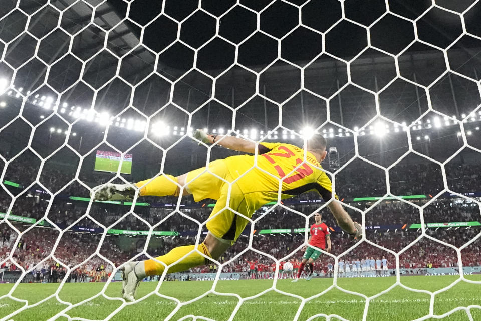 Morocco's Achraf Hakimi scores the decisive penalty during a shootout at the World Cup round of 16 soccer match between Morocco and Spain, at the Education City Stadium in Al Rayyan, Qatar, Tuesday, Dec. 6, 2022. (AP Photo/Luca Bruno)