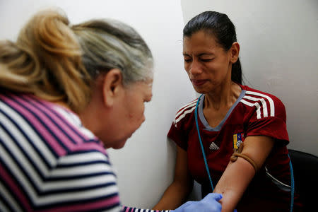 Geraldine Rocca, 29, takes a pregnancy test before her sterilization surgery in Caracas, Venezuela July 26, 2016. REUTERS/Carlos Garcia Rawlins