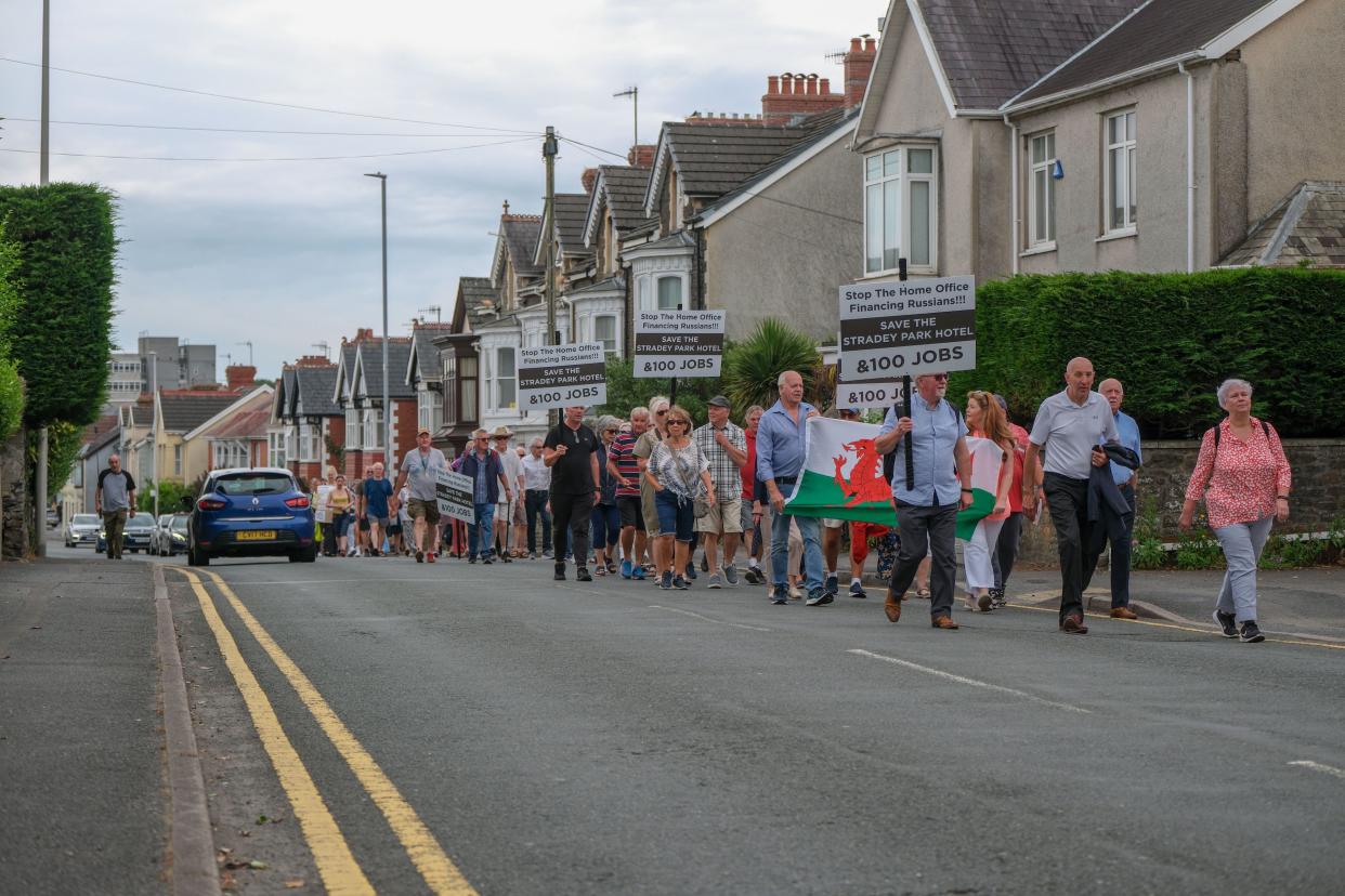 Protesters took to the streets against plans to house illegal immigrants at a 4* hotel in Llanelli, Wales. (gphotography/Shutterstock 13983534f)