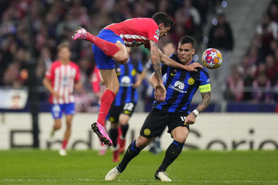 Atletico Madrid's Stefan Savic, left, fights for the ball with Inter Milan's Lautaro Martinez during the Champions League, round of 16, second leg soccer match between Atletico Madrid and Inter Milan at the Metropolitano stadium in Madrid, Spain, Wednesday, March 13, 2024. (AP Photo/Manu Fernandez)