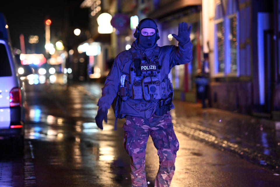 24 February 2020, Hessen, Volkmarsen: A SEK official raises his hand in the street in front of a house that was searched by a SEK unit. A car had previously crashed into a carnival parade.  According to Frankfurt police chief Bereswill, 30 people were injured. Seven of them were seriously injured. Photo: Uwe Zucchi/dpa (Photo by Uwe Zucchi/picture alliance via Getty Images)