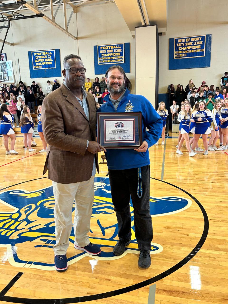 Patriots and Pro Football Hall of Fame linebacker Andre Tippett, left, poses with Hull High football coach Mike O'Donnell at the school on Tuesday, Nov. 29, 2022. O'Connell was named the New England Patriots High School Coach of the Week after his Pirates beat Cohasset, 24-10, on Thanksgiving to improve to 12-0. Hull will play KIPP Academy in the Div. 8 Super Bowl on Saturday, Dec. 3, 2022 at Gillette Stadium.