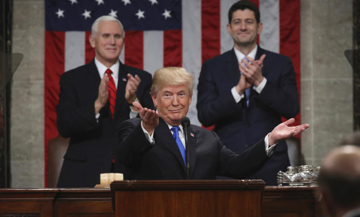 <p>Trump gestures as he delivers his first State of the Union address to a joint session of Congress on Jan. 30, as Vice President Mike Pence, left, and House Speaker Paul Ryan applaud. (Photo: Win McNamee/AP) </p>