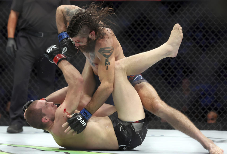 Matthew Semelsberger gets ready to strike Alex Morono on the mat in a welterweight mixed martial arts bout at UFC 277 on Saturday, July 30, 2022, in Dallas. (AP Photo/Richard W. Rodriguez)