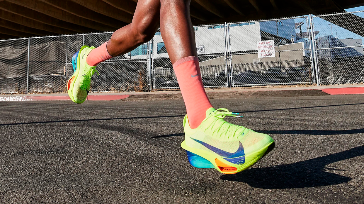  Nike Alphafly 3 running shoes in yellow Volt colorway on feet of runner. 