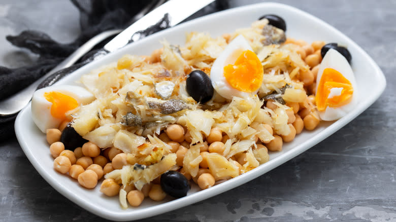 White fish surrounded by chickpeas and eggs