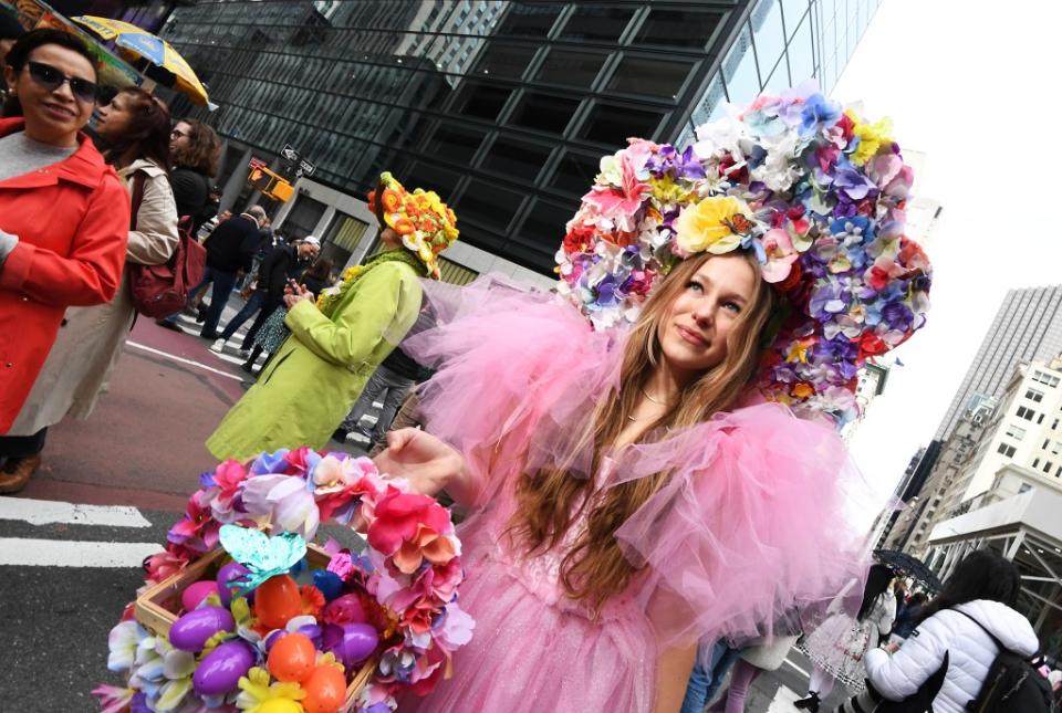 Another parade-goer wears a hat full of flowers to match a pink dress. Matthew McDermott