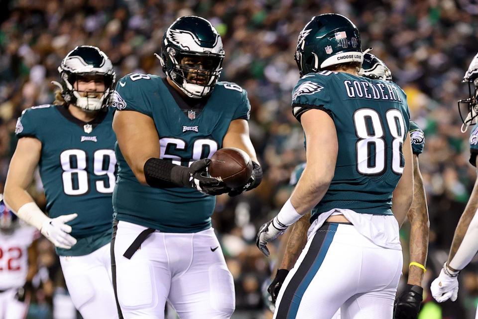 Eagles LT Jordan Mailata (68) celebrates a touchdown with TE Dallas Goedert in Philadelphia's divisional playoff rout of the New York Giants in January.