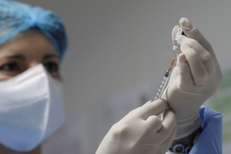 FILE PHOTO: A nurse prepares a dose of the Pfizer-BioNTech coronavirus disease (COVID-19) vaccine