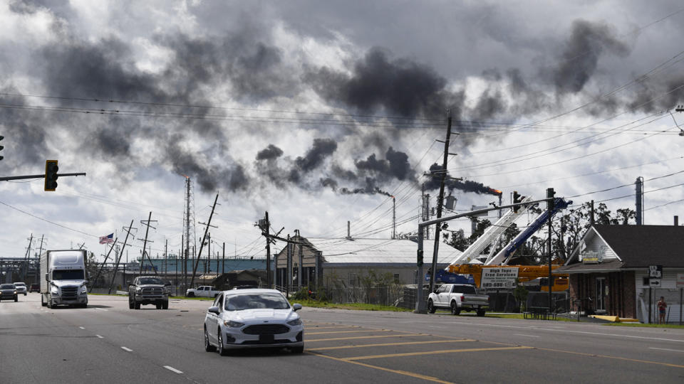 Vehicles drive past a petrochemical plant in Norco, La., after Hurricane Ida made landfall.