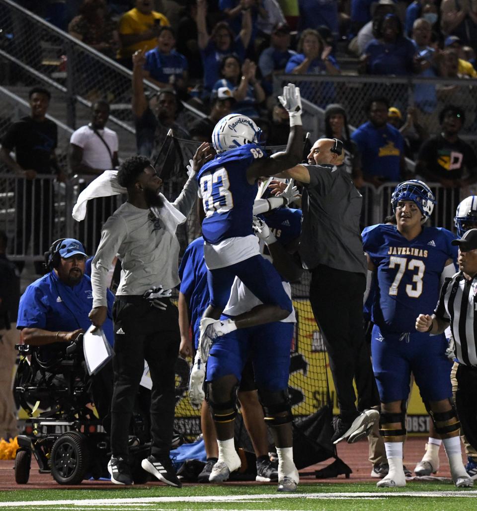 Texas A&M-Kingsville's Craig Clemons celebrates with coach Mike Salinas against Eastern New Mexico in a college football game at Javelina Stadium in Kingsville, Texas on Saturday, Sept. 24, 2022.