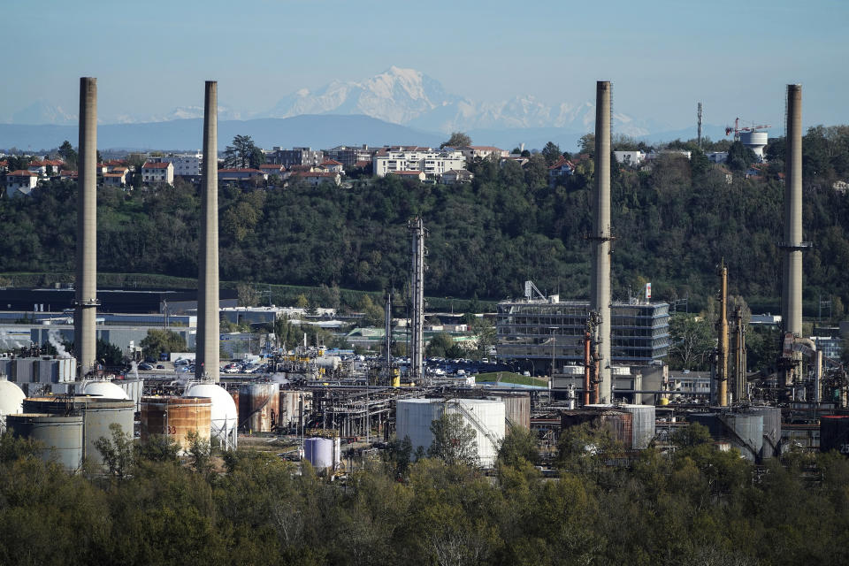 FILE - The Mont Blanc is visible in background with the Feyzin oil refinery, near Lyon, central France, Nov. 7, 2022. The United Nations will require delegates attending its annual climate summit to disclose their affiliation in an effort to clamp down on undue influence by fossil fuel companies and others. (AP Photo/Laurent Cipriani, File)