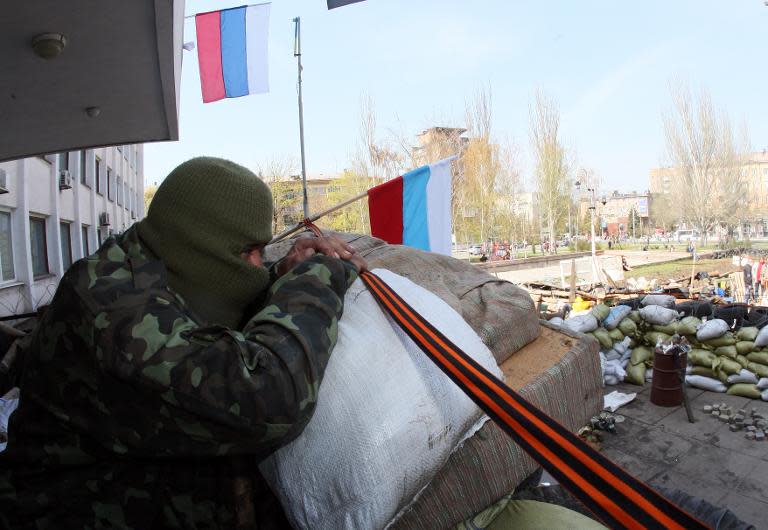 A pro-Russia activist guards a barricade outside the city government building in Mariupol