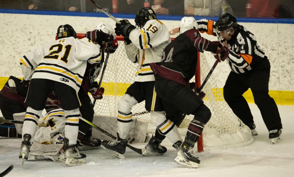 McQuaid and Orchard Park players scramble in front of the net as the puck crosses the goal line. The goal was waved off.