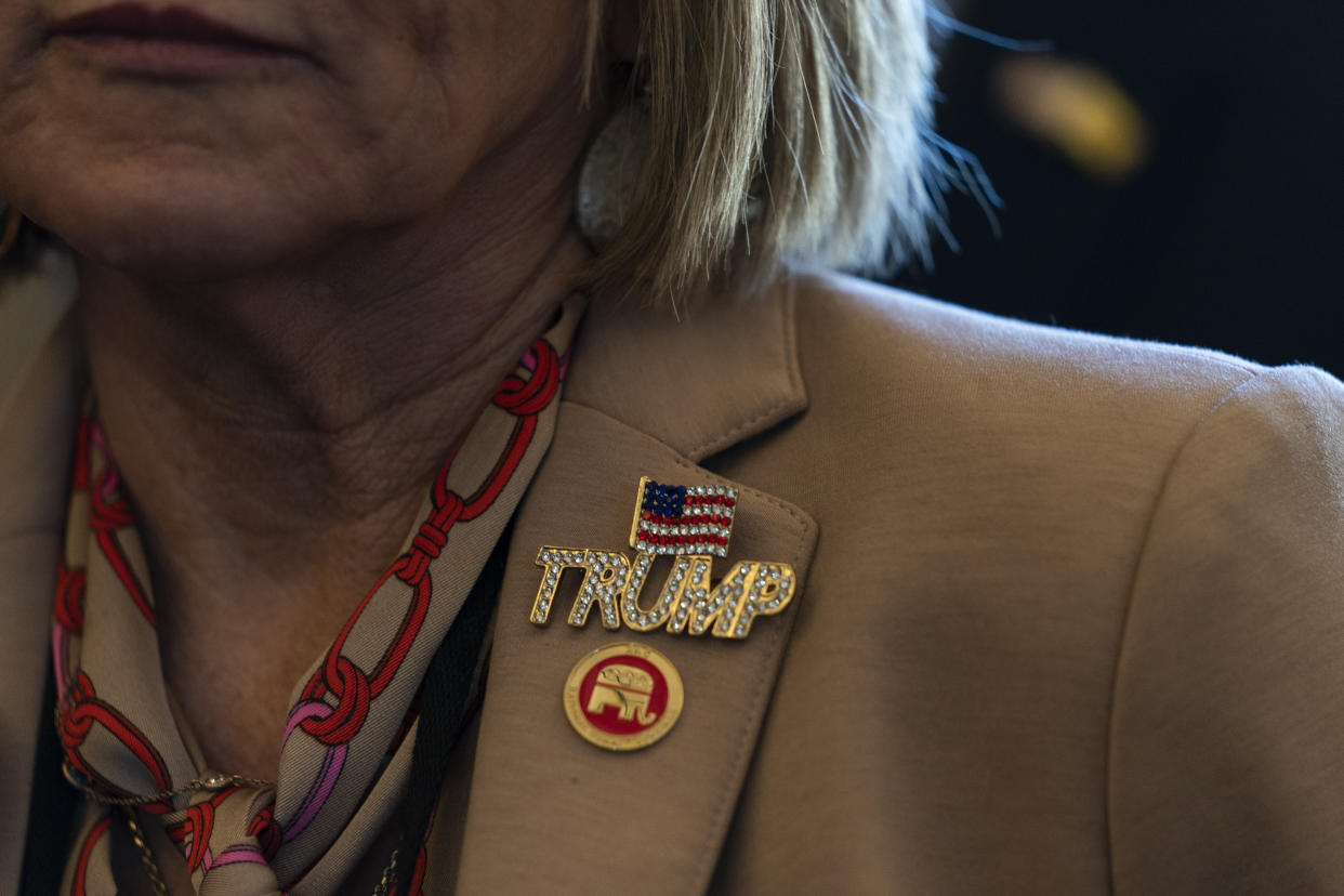 Republican National Committee member Fanchon Blythe wears a pin supporting former President Donald Trump at the Republican National Committee winter meeting in Dana Point, Calif., Friday, Jan. 27, 2023. (AP Photo/Jae C. Hong)