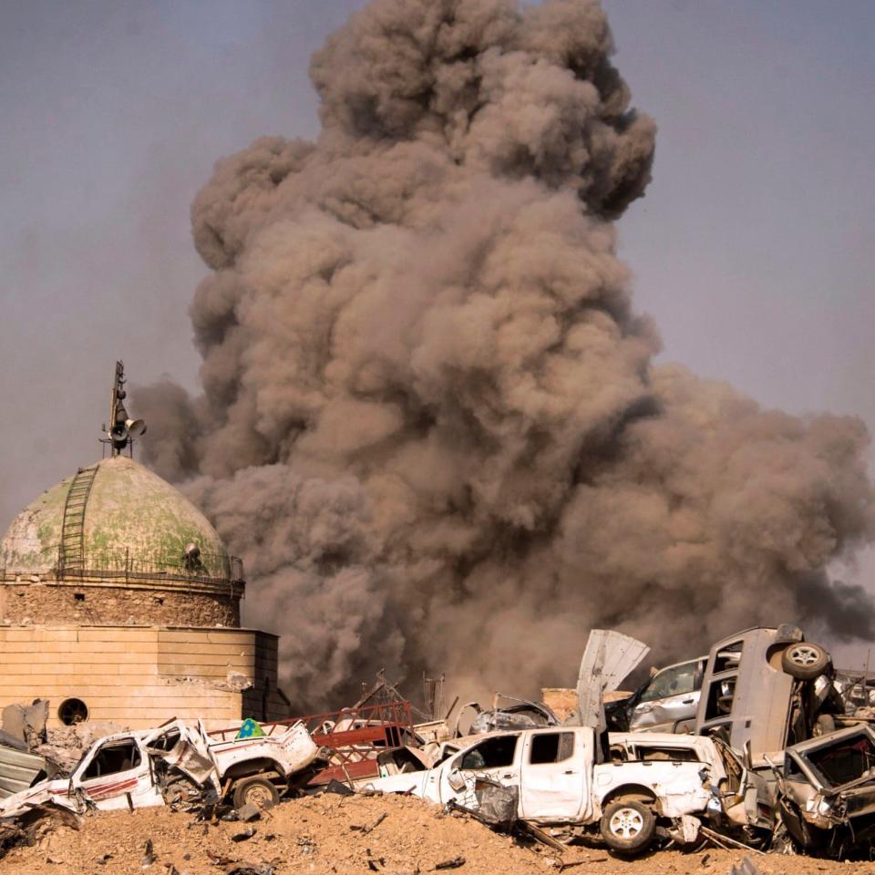 Smoke plumes billowing in the Old City of Mosul during the offensive by the Iraqi force to retake the embattled city from Islamic State  - Credit: AFP