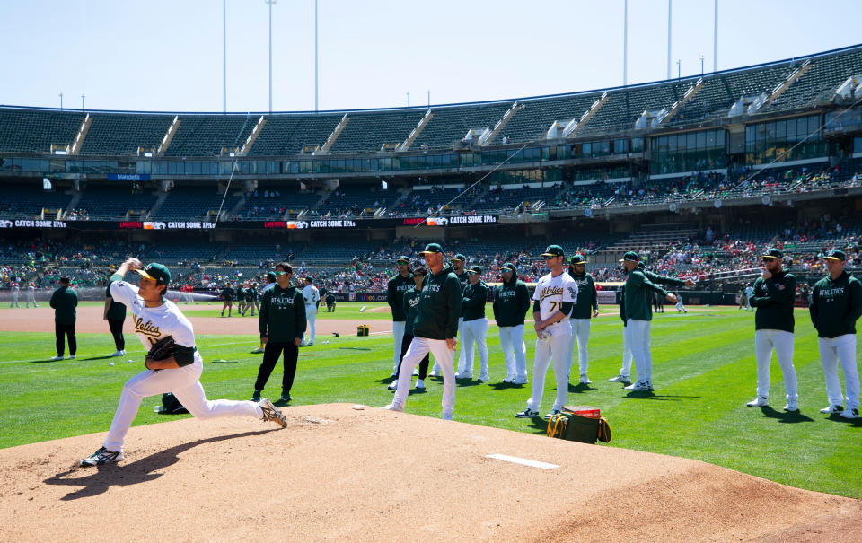 Shintaro Fujinami (now with the Orioles) warms up in the bullpen. (Michael Zagaris/Oakland Athletics/Getty Images)