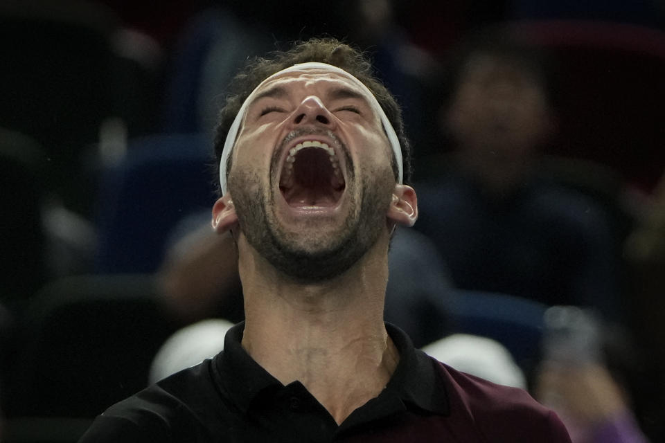 Grigor Dimitrov of Bulgaria celebrates after defeating Carlos Alcaraz of Spain in the 4th round of the men's singles match in the Shanghai Masters tennis tournament at Qizhong Forest Sports City Tennis Center in Shanghai, China, Wednesday, Oct. 11, 2023. (AP Photo/Andy Wong)