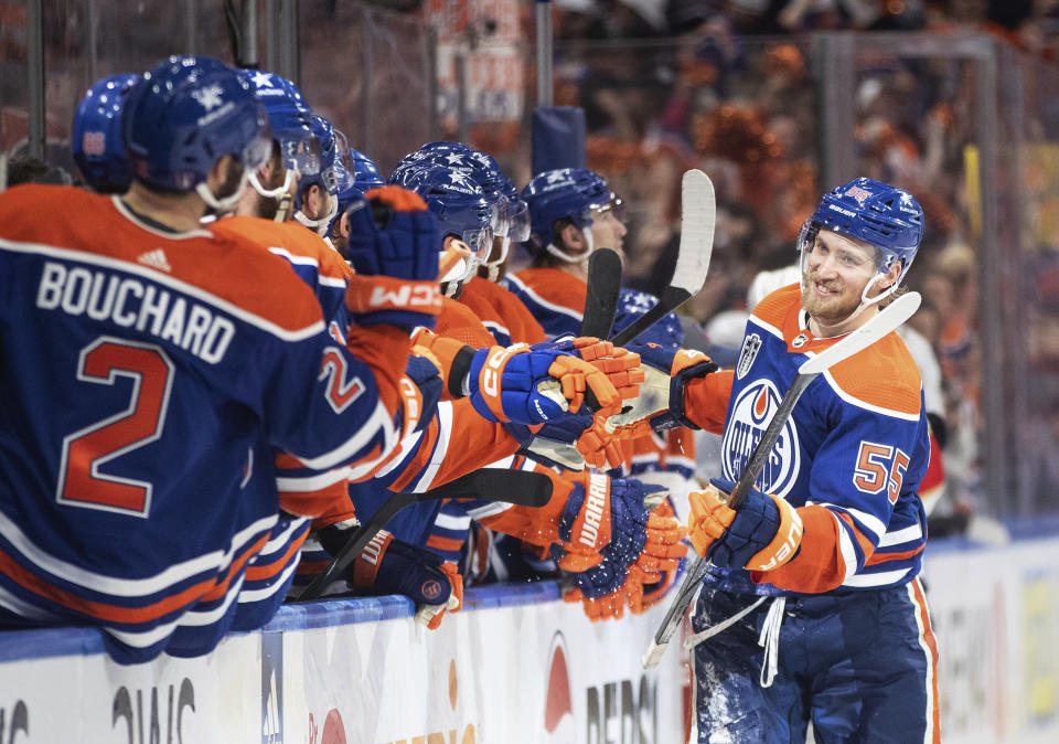Edmonton Oilers' Dylan Holloway (55) is congratulated for a goal against the Florida Panthers during the third period of Game 4 of the NHL hockey Stanley Cup Final, Saturday, June 15, 2024, in Edmonton, Alberta. (Jason Franson/The Canadian Press via AP)