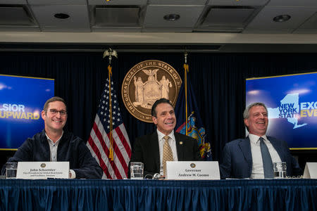 FILE PHOTO: Vice President of Global Real Estate and Facilities from Amazon John Schoettler, New York Governor Andrew Cuomo and New York Mayor Bill de Blasio speak during a news conference about Amazon's headquarters, November 13, 2018. REUTERS/Jeenah Moon/File Photo