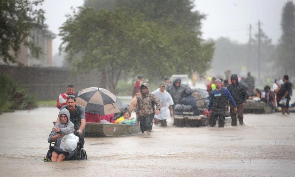 People are rescued from a flooded Houston neighbourhood