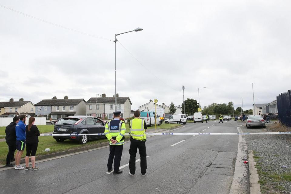 Balbutcher Drive in Ballymun, Dublin, was sealed off after a fatal double shooting (PA)