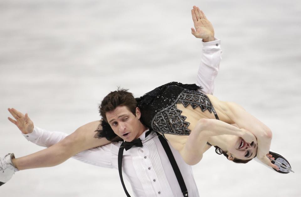 Tessa Virtue and Scott Moir of Canada compete in the ice dance short dance figure skating competition at the Iceberg Skating Palace during the 2014 Winter Olympics, Sunday, Feb. 16, 2014, in Sochi, Russia. (AP Photo/Bernat Armangue)