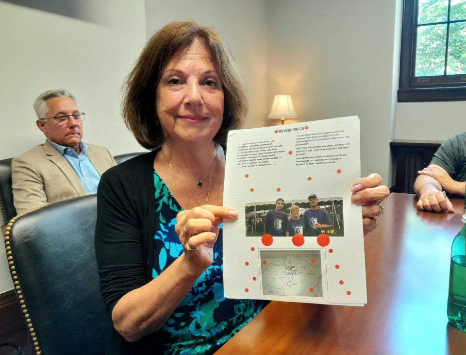 Susie Gaffney, 66, who now lives in O’Fallon, Missouri, holds a packet of papers that she distributed to lawmakers on Capitol Hill on March 22, 2024. The packet contained photos of her son Joey, 45, who developed thyroid cancer at 18, and her husband, Jim, 68, who survived bladder cancer and now lives with myelodysplastic syndrome. Three generations of her family lived along Coldwater Creek, which is contaminated with radioactive waste. (Ashley Murray/States Newsroom)