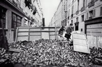 <p>Although universities were closed during the student riots, elementary schools remained open, and young children attended classes, climbing over paving stones at a barricade erected by students, Rue de l’Université, Paris, June 11, 1968. (Photo: Gökşin Sipahioğlu/SIPA) </p>