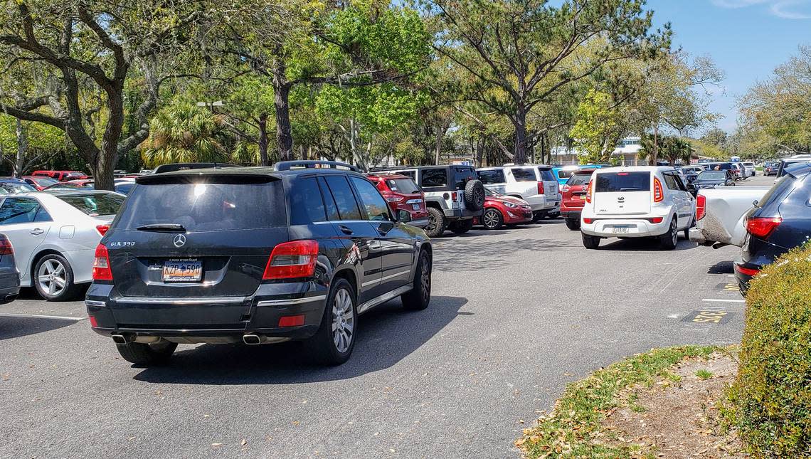 Cars begin stacking as one vehicle waits for a person to leave their parking space in a full Coligny Beach Park parking lot as seen on Thursday, March 19, 2020.