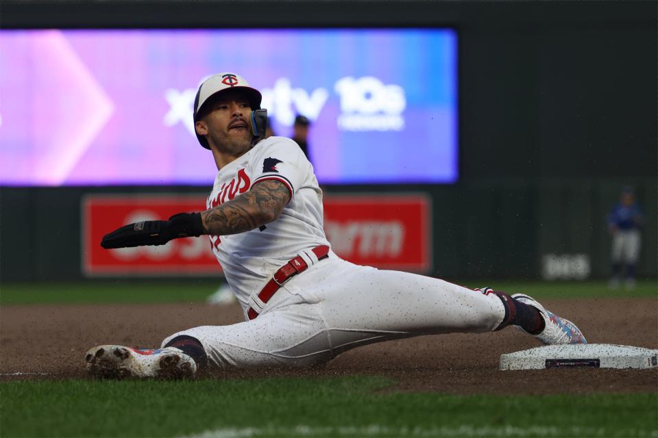 Carlos Correa slides into third in the eighth inning of the Twins' Game 2 win over the Blue Jays.