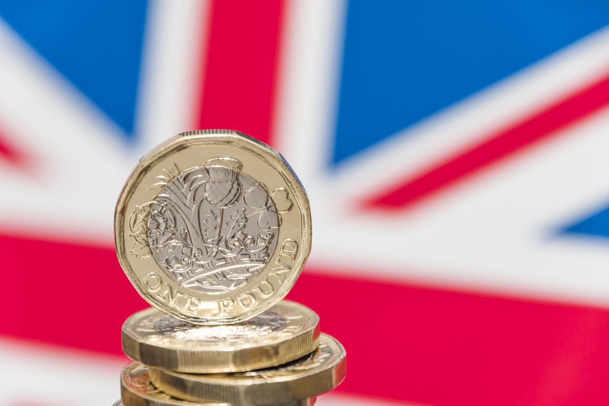 New UK £1 coin with British union jack flag. Photo: Getty