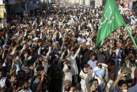 Supporters of Tehreek-e-Labiak Pakistan, a radical Islamist political party, chant slogans prior to start their march toward Islamabad, in Lahore, Pakistan, Friday, Oct. 22, 2021. Thousands of Islamists launched their "long march" from the eastern city of Lahore toward Pakistan's capital, demanding that the government release the leader of their Saad Rizvi, who was arrested last year amid demonstrations against France over publishing caricatures of Islam's Prophet Muhammad. (AP Photo/K.M. Chaudary)